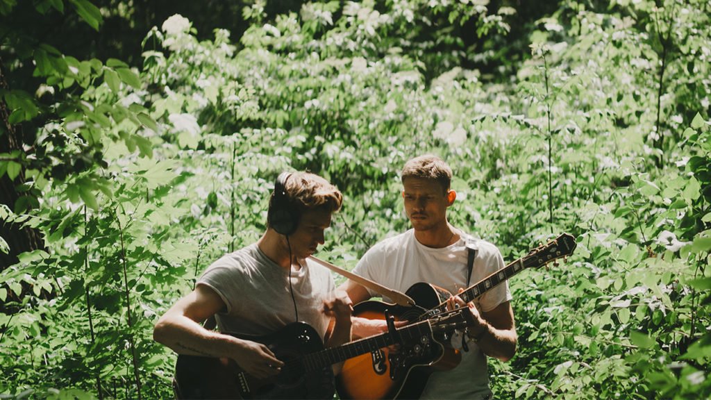 two guy playing guitar in forest music inspiration